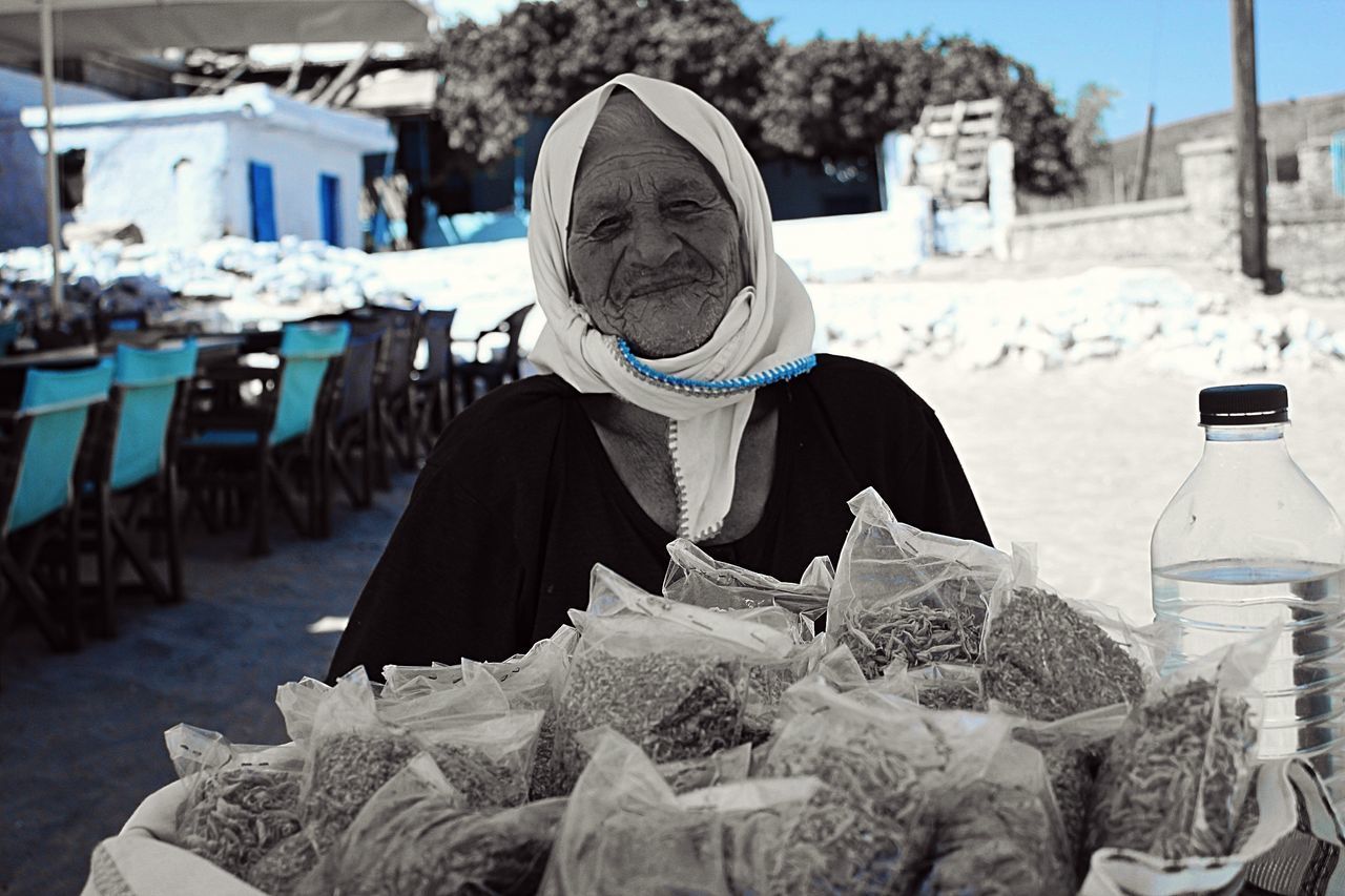 PORTRAIT OF WOMAN WITH SNOW COVERED MARKET