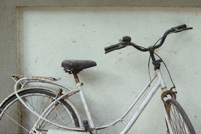 Close-up of bicycle against wall