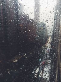 Full frame shot of wet glass window in rainy season