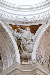 Low angle view of sculptures on ceiling of building