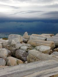 Rocks on beach against sky