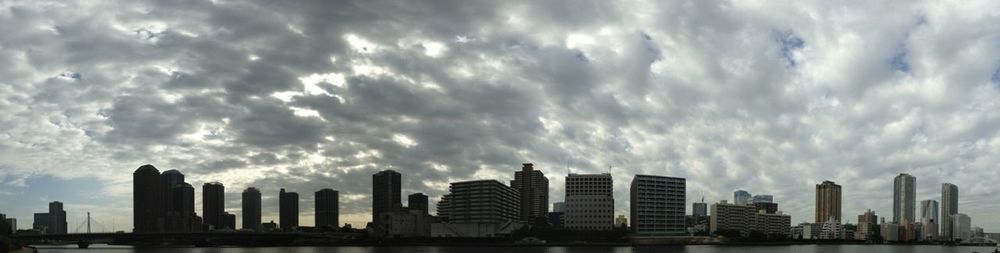 City skyline against cloudy sky
