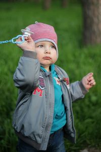 Cute boy standing on field