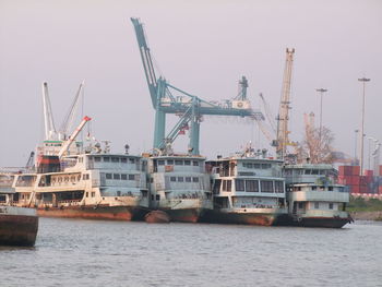 Ship moored at harbor against clear sky