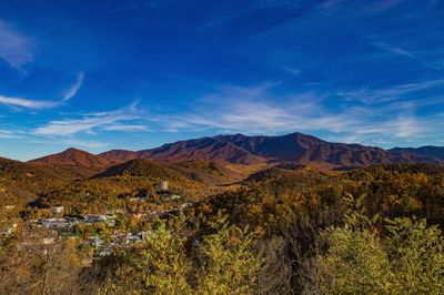 Scenic view of mountains against blue sky