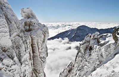 Low angle view of snow covered mountain against sky