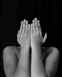 Close-up of woman hand against black background