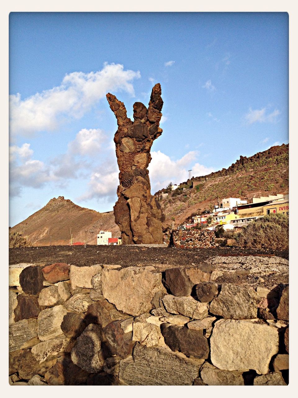 transfer print, sky, auto post production filter, low angle view, cloud - sky, cloud, blue, human representation, built structure, sculpture, day, art and craft, architecture, building exterior, statue, art, outdoors, animal representation, no people