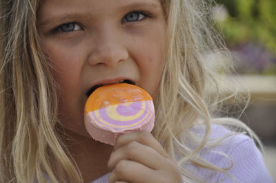 Close-up portrait of a girl holding ice cream