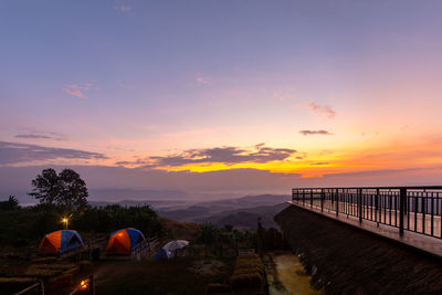 Panoramic view of illuminated land against sky during sunset