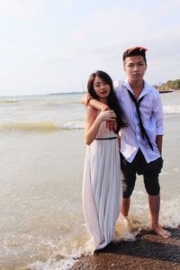 Young couple standing on beach