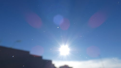 Low angle view of moon against blue sky