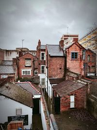 Residential buildings in city against sky