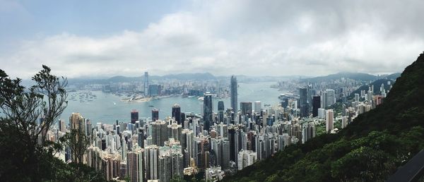 Cityscape against cloudy sky