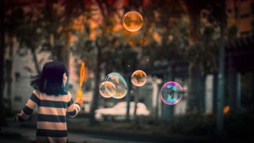 Rear view of woman in bubbles