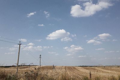 Ukrainian steppe landscape with power lines supports