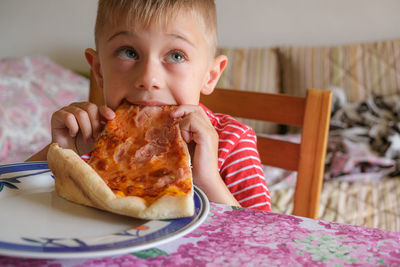 Portrait of boy eating food