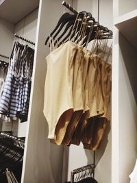 Close-up of clothes hanging on rack in store