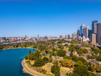 Panoramic view of city buildings against clear blue sky