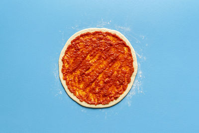 Directly above shot of pizza against blue background