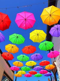 Low angle view of colorful umbrellas against sky