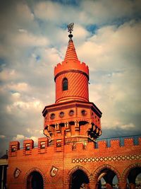 Low angle view of built structure against cloudy sky