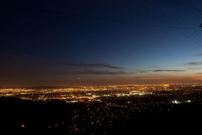 High angle view of illuminated buildings against sky at sunset