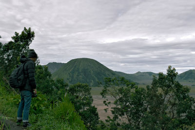 Full length of man looking at mt bromo