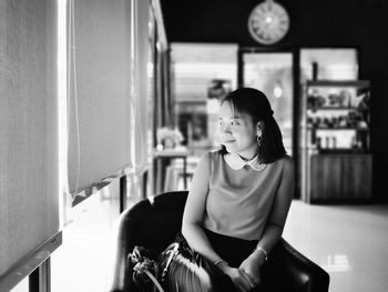 Full length of woman sitting on chair