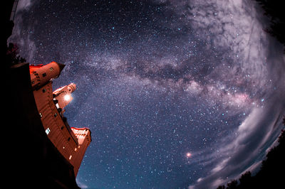 Low angle view of building against star field at night