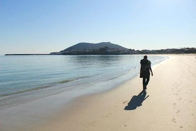 Full length of woman standing on beach