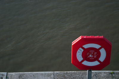 High angle view of life belt on pier over sea