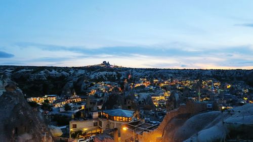 Illuminated buildings at cappadocia against sky during dusk