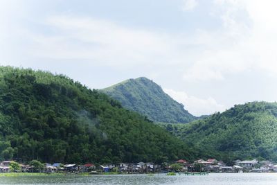 Scenic view of lake by trees against sky