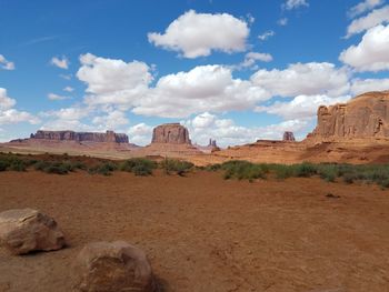 Panoramic view of desert against cloudy sky
