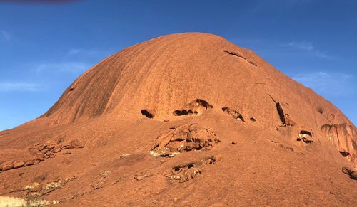 Scenic view of desert against blue sky