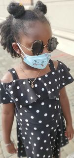 Midsection of girl holding umbrella