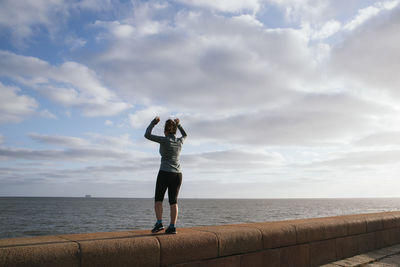 Girl exercising near the sea