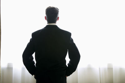 Rear view of man standing against sky