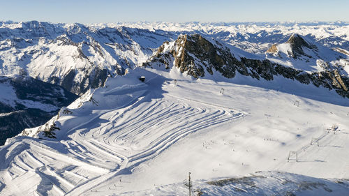 Ski tracks on white sunny snowed slopes of austrian alps