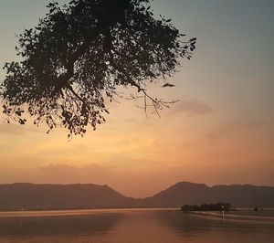 Scenic view of lake at sunset