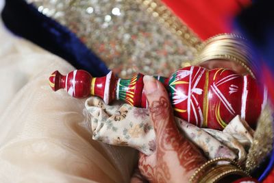 Cropped image of woman holding red container