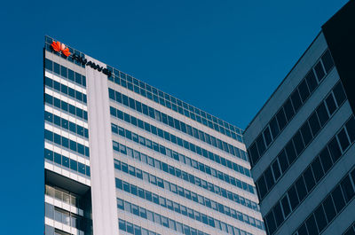 Low angle view of modern building against clear blue sky