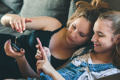 Low section of man and woman using smart phone