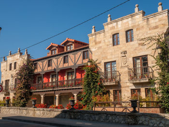 Low angle view of buildings against blue sky