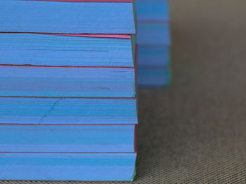 Close-up of books on table against wall