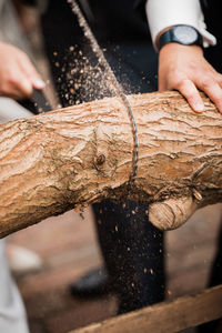 Midsection of man working on wood