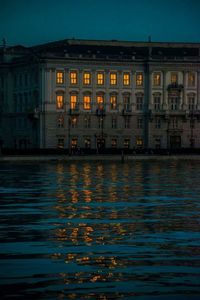 Reflection of building in sea at night