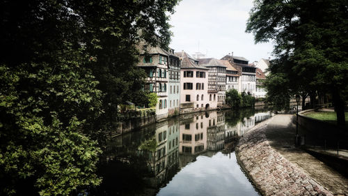 Canal amidst buildings against sky