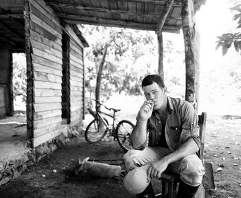 Full length of man sitting outdoors